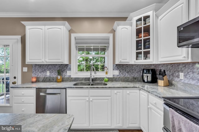 kitchen with a sink, white cabinets, glass insert cabinets, and appliances with stainless steel finishes