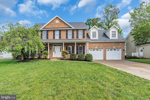 view of front facade with driveway, brick siding, and a front yard
