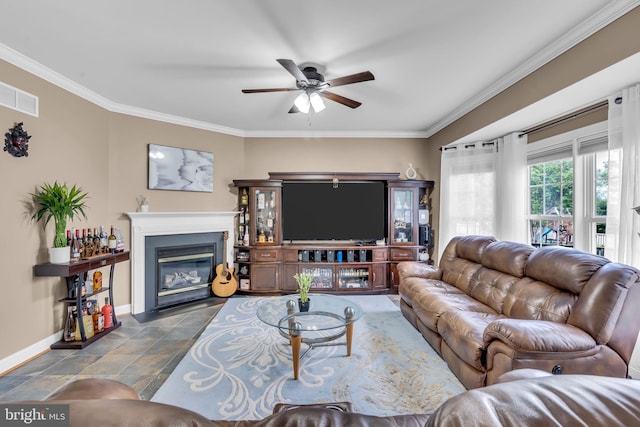 living room with a ceiling fan, baseboards, visible vents, crown molding, and a fireplace with flush hearth