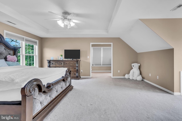 carpeted bedroom featuring baseboards, ceiling fan, a tray ceiling, and visible vents