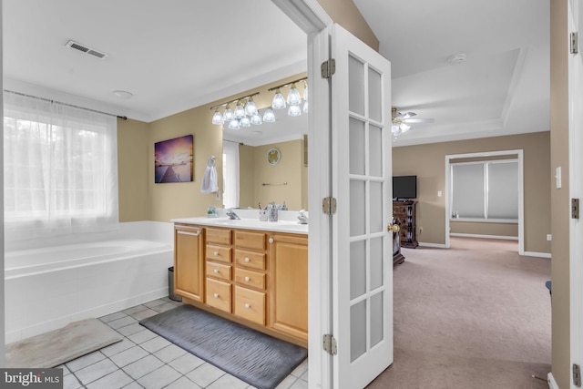 full bathroom featuring double vanity, tile patterned floors, a bath, visible vents, and ceiling fan