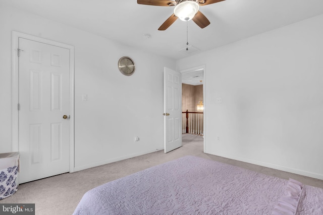 carpeted bedroom featuring baseboards and ceiling fan