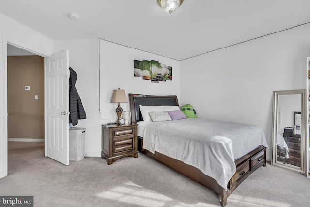 bedroom featuring carpet flooring and baseboards