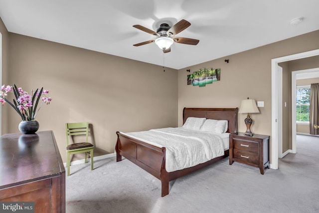 carpeted bedroom with baseboards and a ceiling fan