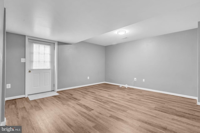 interior space with light wood finished floors and baseboards
