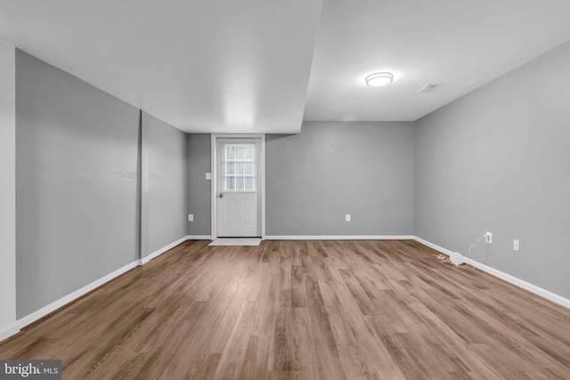 basement featuring wood finished floors and baseboards