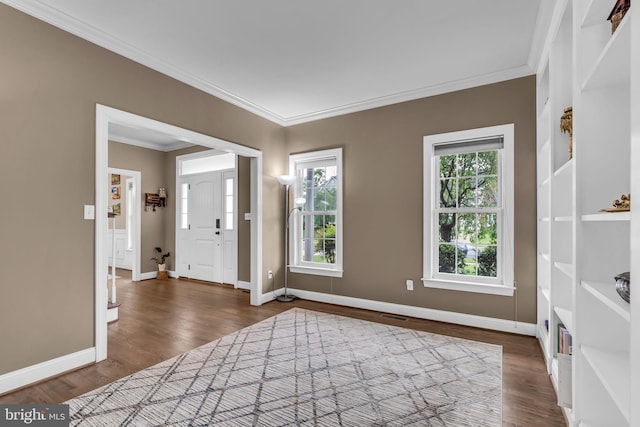 foyer entrance with baseboards, ornamental molding, and dark wood-style floors