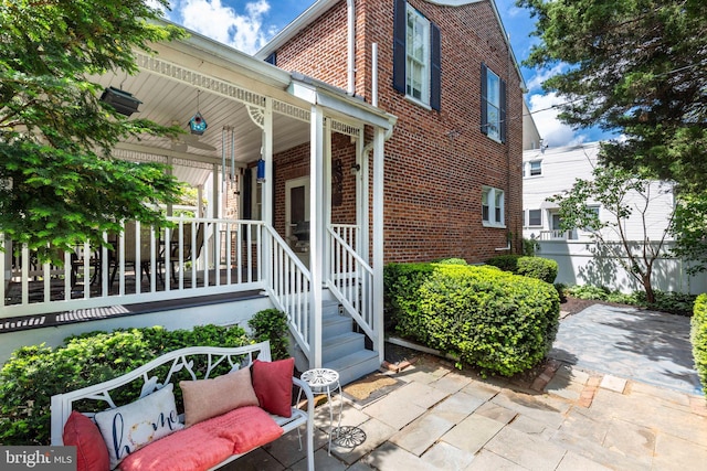 140 Pennsylvania Ave, Westminster, MD 21157 - doorway to property with brick siding and a porch