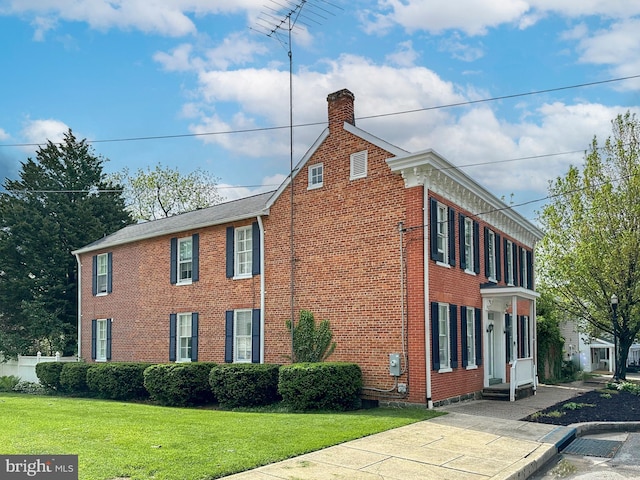 140 Pennsylvania Ave, Westminster, MD 21157 - view of side of property featuring a chimney, brick siding, and a yard