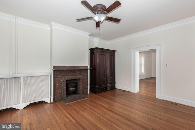140 Pennsylvania Ave, Westminster, MD 21157 - unfurnished living room with a wood stove, wood-type flooring, crown molding, and a ceiling fan