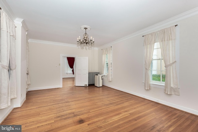 140 Pennsylvania Ave, Westminster, MD 21157 - unfurnished living room featuring a chandelier, light wood finished floors, ornamental molding, and radiator