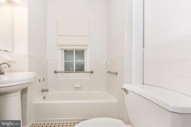 140 Pennsylvania Ave, Westminster, MD 21157 - bathroom featuring tile walls, a tub to relax in, and wainscoting