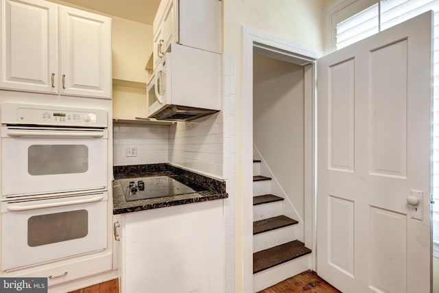 140 Pennsylvania Ave, Westminster, MD 21157 - kitchen featuring double oven, black electric cooktop, backsplash, white cabinetry, and dark stone counters