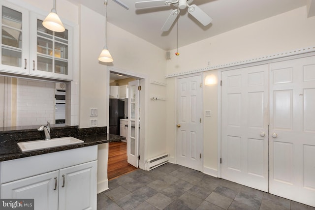140 Pennsylvania Ave, Westminster, MD 21157 - kitchen featuring a baseboard radiator, a ceiling fan, white cabinetry, and glass insert cabinets
