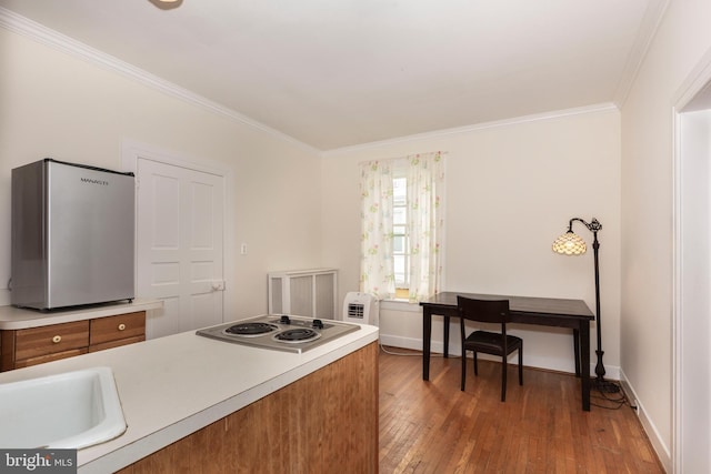 140 Pennsylvania Ave, Westminster, MD 21157 - kitchen with freestanding refrigerator, ornamental molding, electric cooktop, brown cabinets, and wood-type flooring