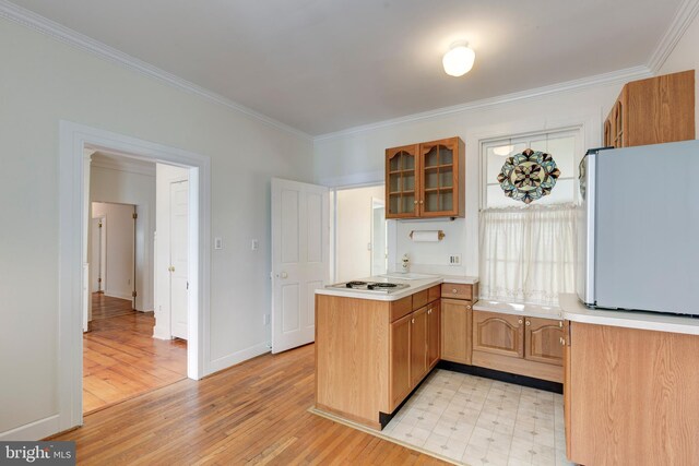 140 Pennsylvania Ave, Westminster, MD 21157 - kitchen featuring white appliances, ornamental molding, glass insert cabinets, a peninsula, and light countertops