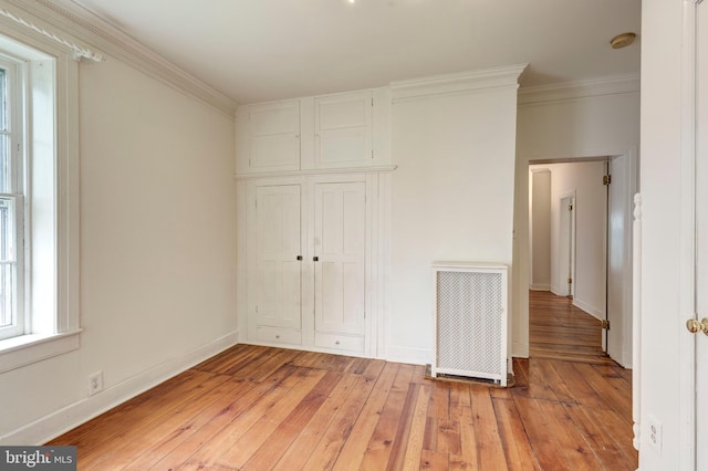 140 Pennsylvania Ave, Westminster, MD 21157 - unfurnished bedroom featuring radiator heating unit, crown molding, light wood-style floors, and a closet