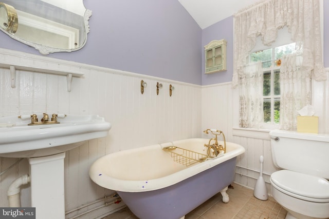 140 Pennsylvania Ave, Westminster, MD 21157 - bathroom with a freestanding bath, wainscoting, tile patterned floors, and lofted ceiling