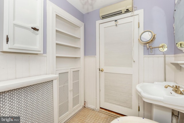 140 Pennsylvania Ave, Westminster, MD 21157 - bathroom featuring a wall mounted air conditioner, a wainscoted wall, and a decorative wall