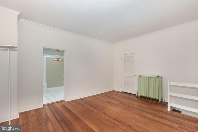 140 Pennsylvania Ave, Westminster, MD 21157 - spare room featuring crown molding, hardwood / wood-style floors, and radiator heating unit
