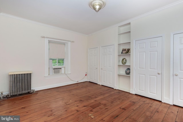 140 Pennsylvania Ave, Westminster, MD 21157 - unfurnished bedroom featuring radiator, crown molding, wood-type flooring, multiple closets, and cooling unit