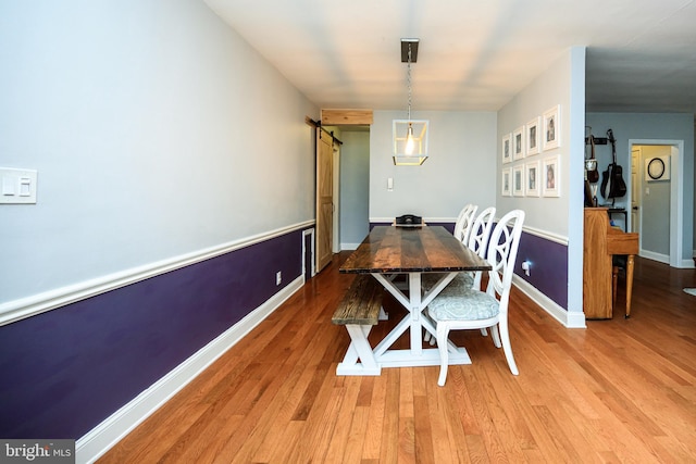 877 Salford Station Rd, Schwenksville, PA 19473 - dining room featuring a barn door, light wood-style floors, and baseboards