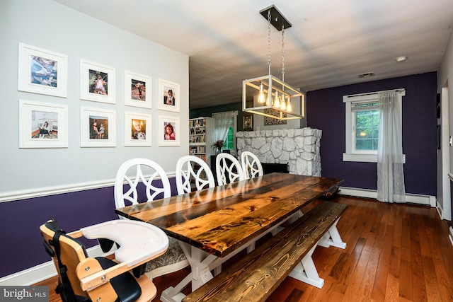 877 Salford Station Rd, Schwenksville, PA 19473 - dining area with a baseboard radiator, hardwood / wood-style flooring, a fireplace, and baseboards