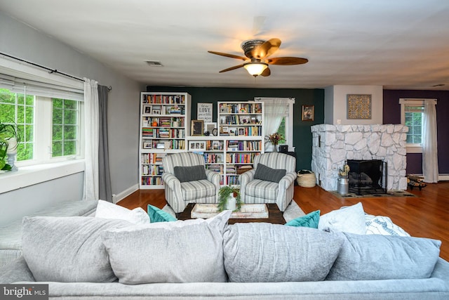 877 Salford Station Rd, Schwenksville, PA 19473 - living area featuring ceiling fan, wood finished floors, and a stone fireplace