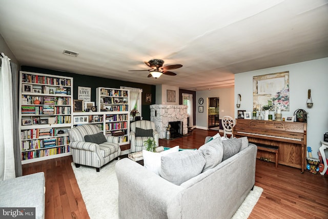 877 Salford Station Rd, Schwenksville, PA 19473 - living area featuring a stone fireplace, a ceiling fan, and wood finished floors