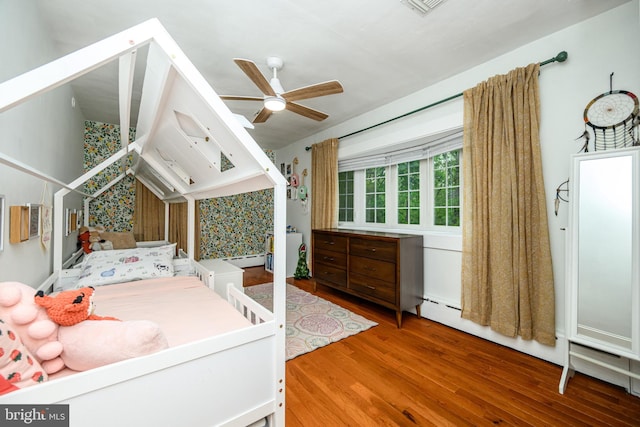 877 Salford Station Rd, Schwenksville, PA 19473 - bedroom with wood finished floors, baseboard heating, and ceiling fan