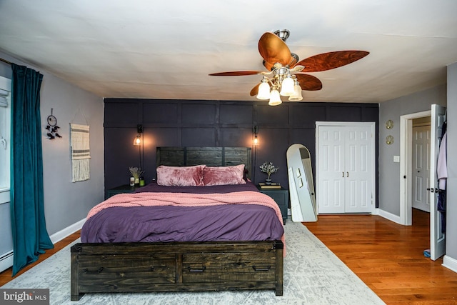 877 Salford Station Rd, Schwenksville, PA 19473 - bedroom featuring wood finished floors, baseboards, a ceiling fan, and a baseboard radiator