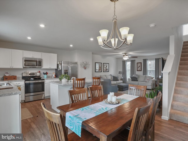171 Cougill Rd, Middletown, VA 22645 - dining room with stairway, wood finished floors, a chandelier, ceiling fan, and recessed lighting