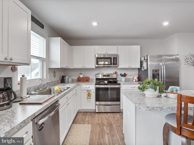 171 Cougill Rd, Middletown, VA 22645 - kitchen featuring stainless steel appliances, a sink, light countertops, white cabinets, and light wood finished floors