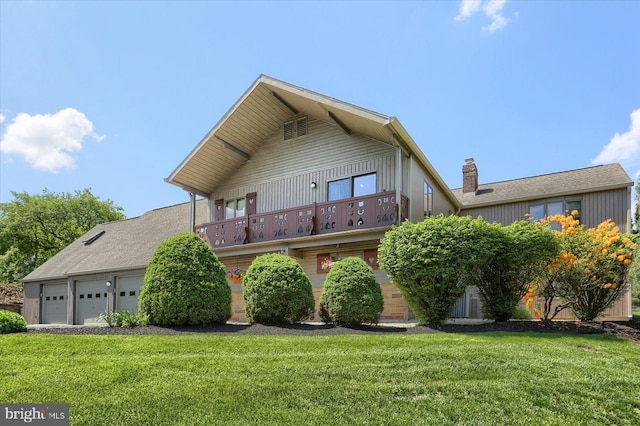 44 Banbury Rd, Hummelstown, PA 17036 - view of front of house with a balcony, a garage, a front lawn, and a chimney