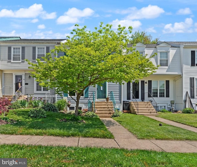 view of property featuring a front lawn