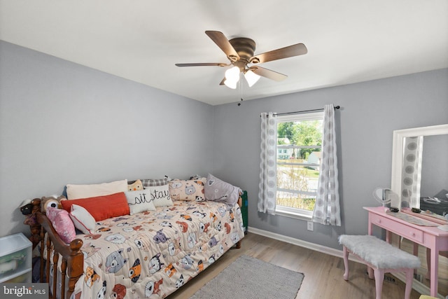 bedroom with baseboards, a ceiling fan, and wood finished floors