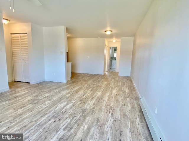 4901 Harbor Beach Blvd Unit P12, Brigantine, NJ 08203 - empty room with ceiling fan, baseboards, a baseboard heating unit, and wood finished floors