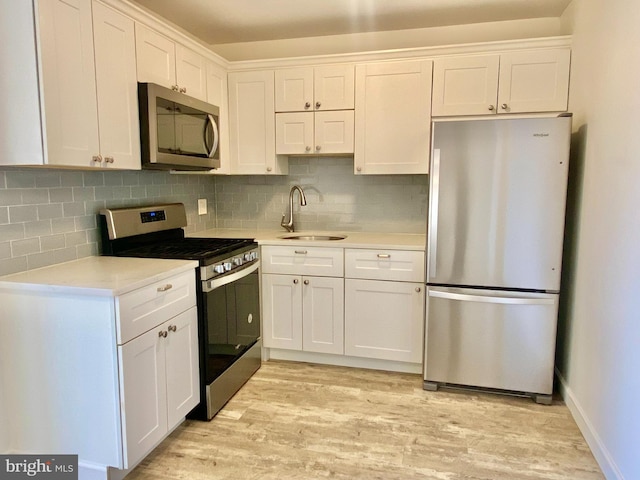 4901 Harbor Beach Blvd Unit P12, Brigantine, NJ 08203 - kitchen with appliances with stainless steel finishes, a sink, light countertops, white cabinetry, and light wood-type flooring