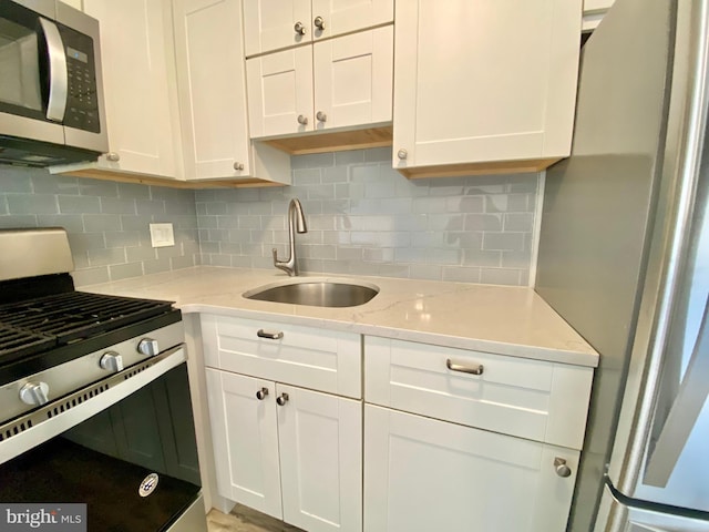 4901 Harbor Beach Blvd Unit P12, Brigantine, NJ 08203 - kitchen featuring decorative backsplash, light stone countertops, a sink, stainless steel appliances, and white cabinetry