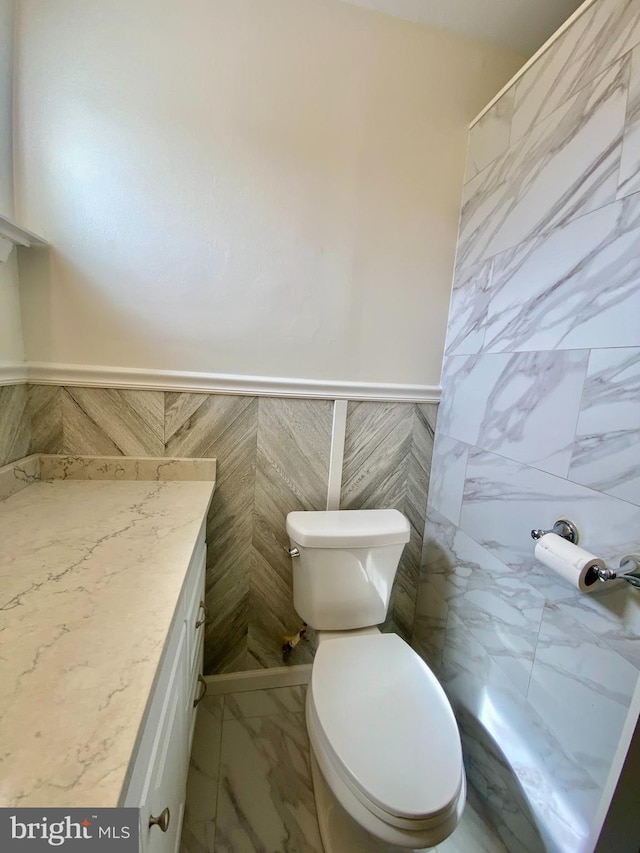 4901 Harbor Beach Blvd Unit P12, Brigantine, NJ 08203 - bathroom featuring vanity, marble finish floor, wainscoting, toilet, and tile walls