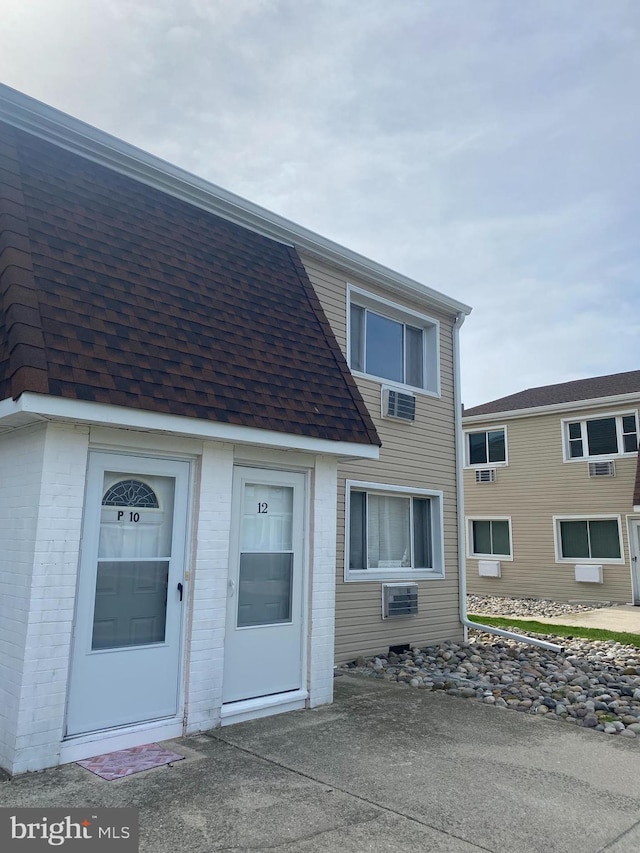 4901 Harbor Beach Blvd Unit P12, Brigantine, NJ 08203 - exterior space featuring brick siding and roof with shingles
