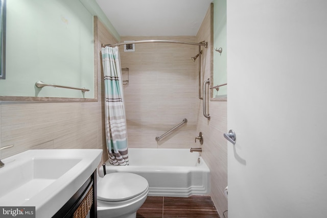 bathroom with vanity, toilet, tile walls, and shower / tub combo with curtain
