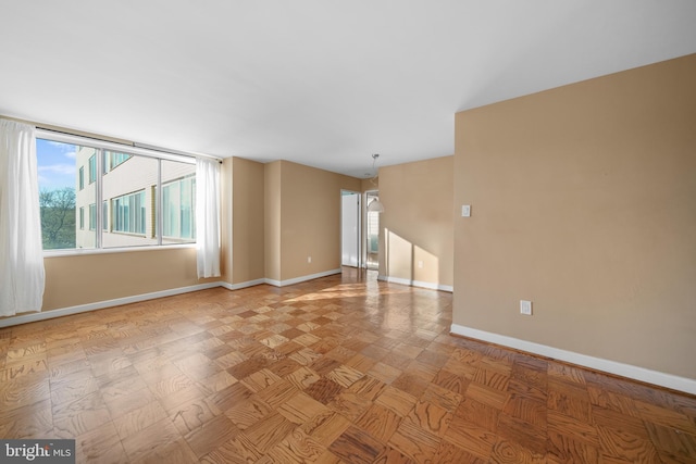 unfurnished room featuring baseboards