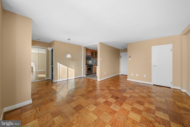 unfurnished living room featuring baseboards