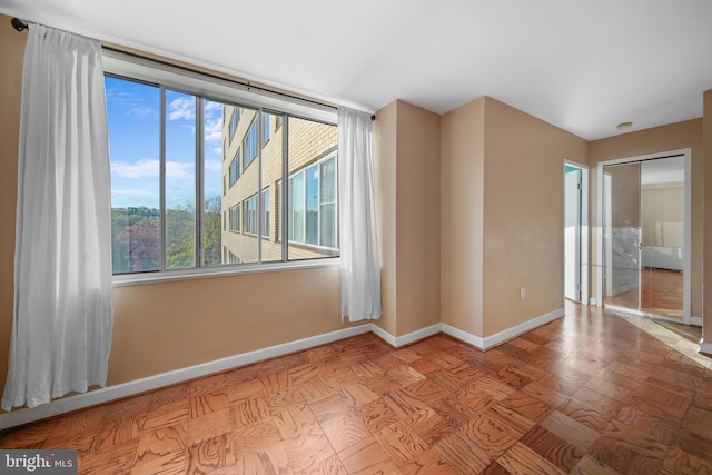 empty room featuring baseboards
