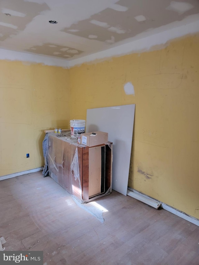 miscellaneous room with baseboards and wood finished floors