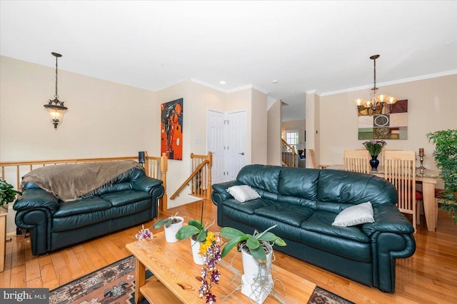 living area featuring a chandelier, wood finished floors, and ornamental molding