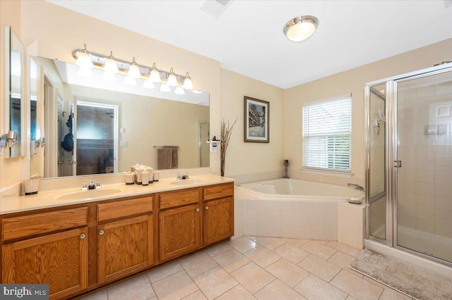 full bath with tile patterned floors, a stall shower, a garden tub, and double vanity