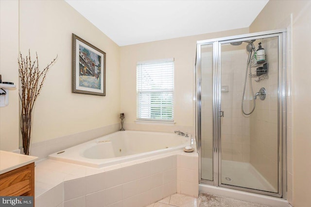 bathroom featuring a bath, a stall shower, vanity, and tile patterned floors