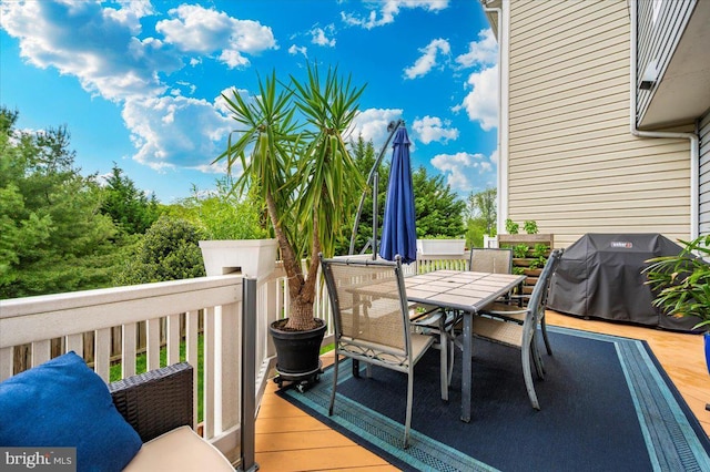 deck featuring area for grilling and outdoor dining space